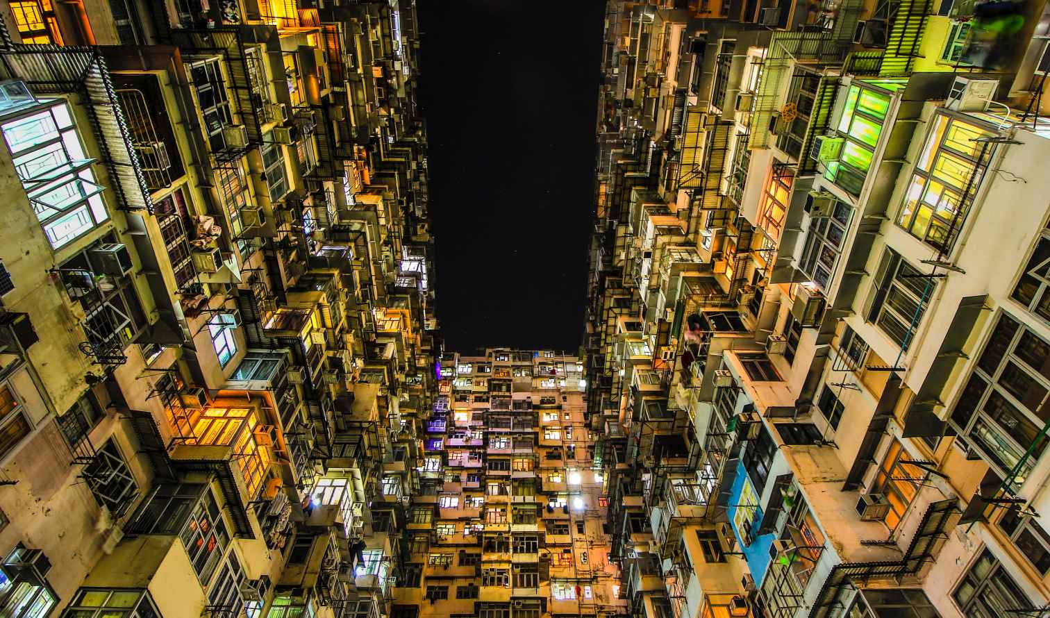 Tall apartment blocks with lit windows in Hong Kong's Quarry Bay district.