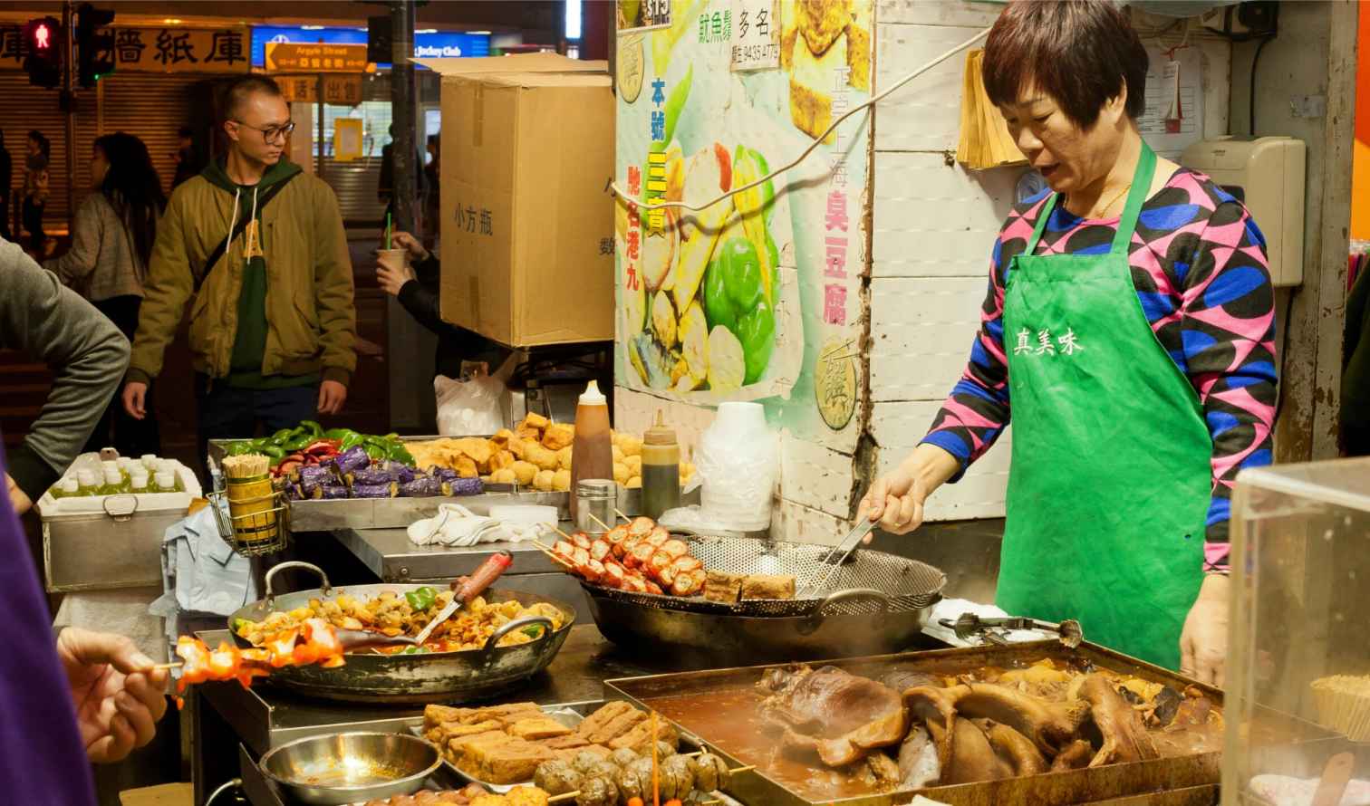 Street food vendor preparing dishes at Mong Kok, Hong Kong.