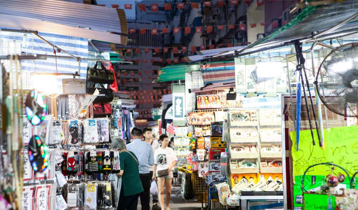 Shoppers browse through merchandise at a night market in Hong Kong.