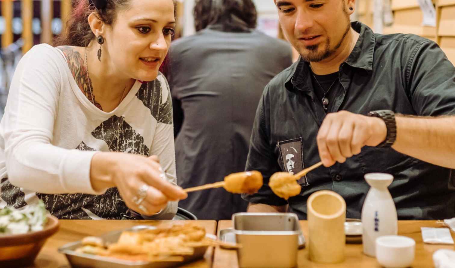Two people dining at a Japanese restaurant table in Kobe