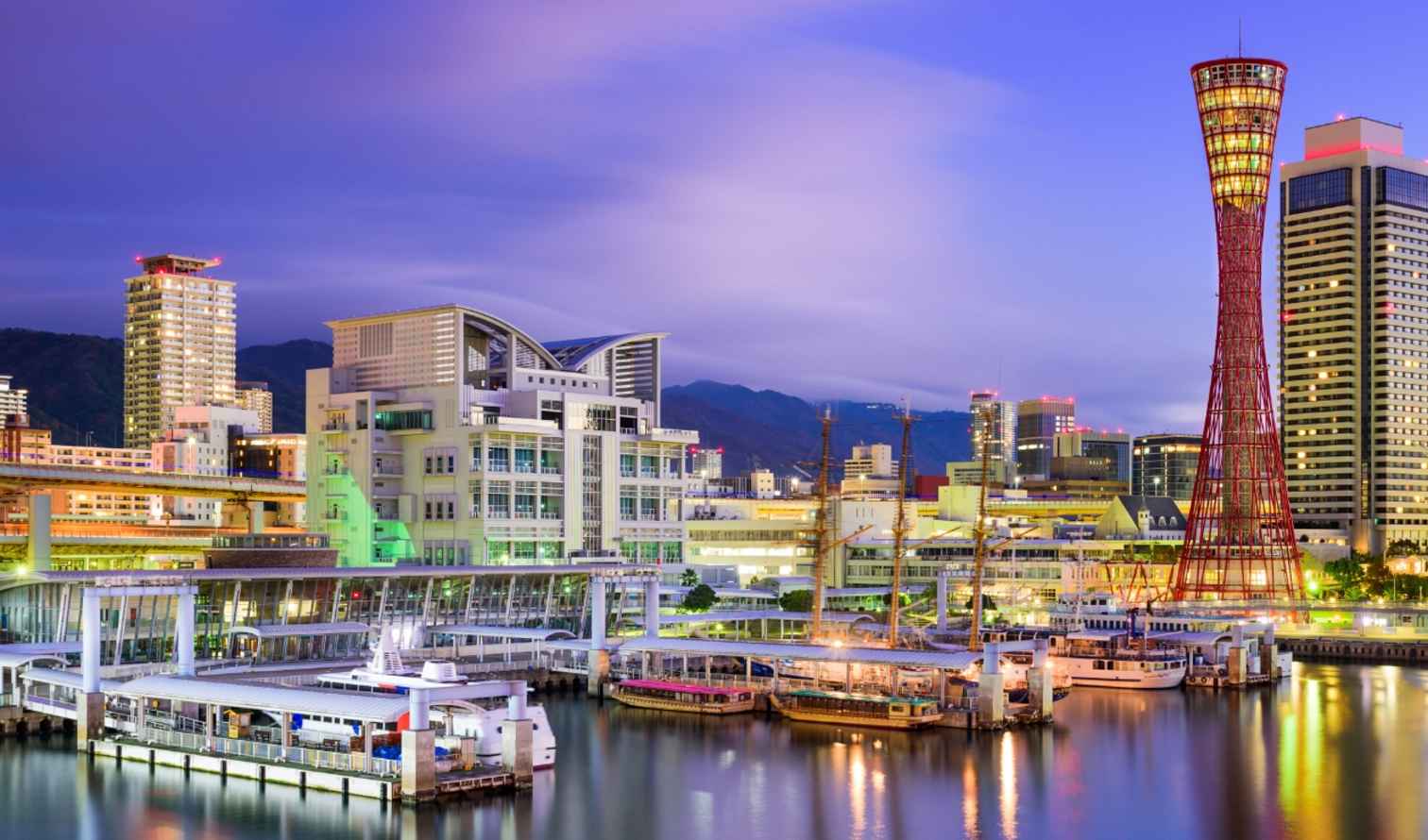 Kobe Port Tower and Maritime Museum in Kobe, Japan at twilight.