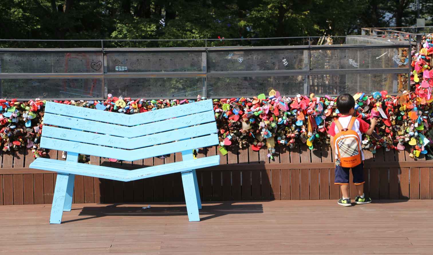 Child standing at love locks on Namsan Tower, Seoul.