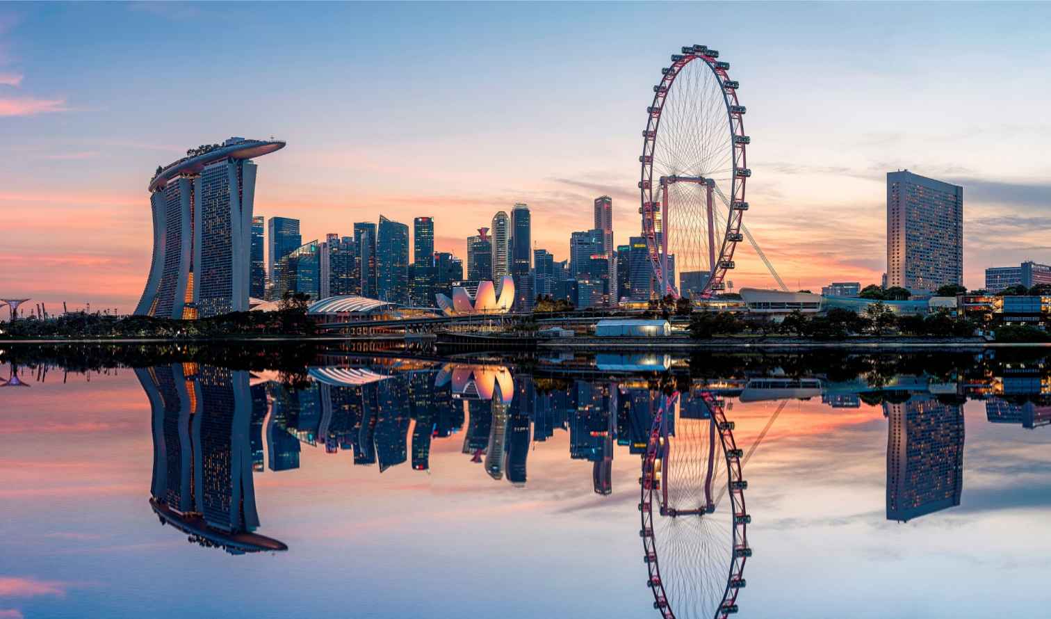 View of Marina Bay Sands and Singapore Flyer at sunset.