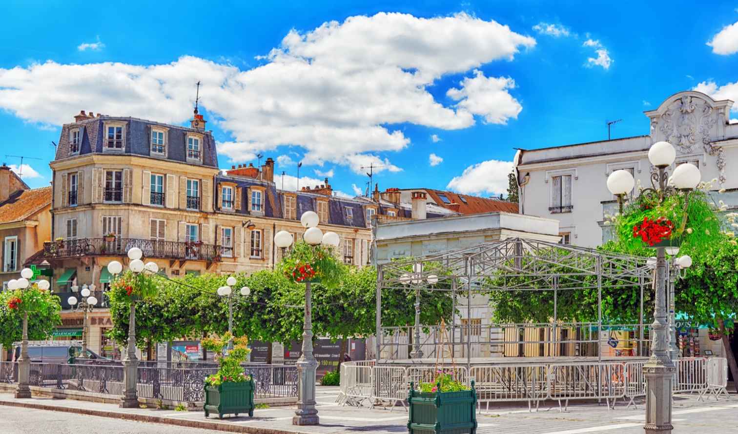 People walking in front of residential buildings in Paris' Montmartre neighborhood.