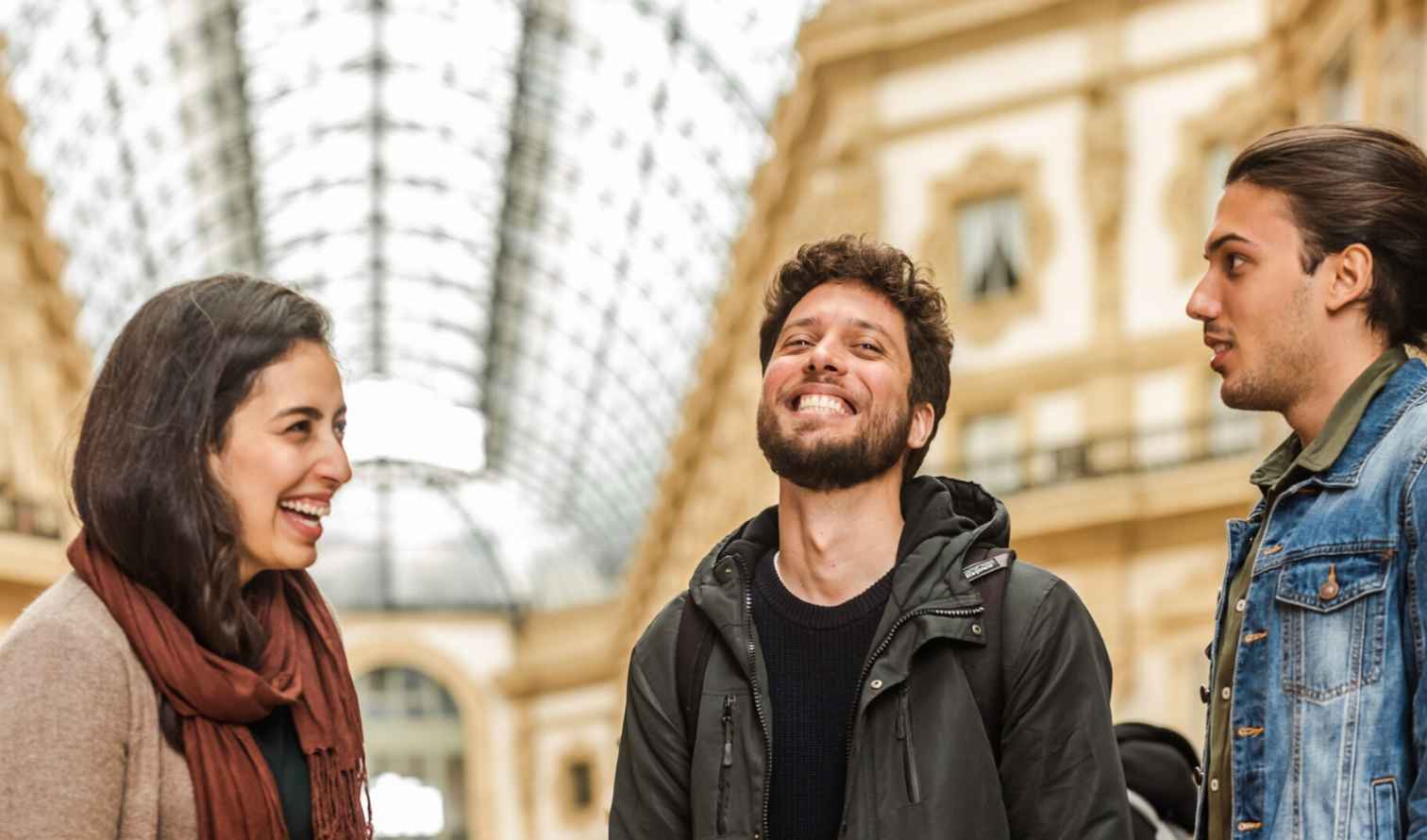 Three people talking inside Galleria Vittorio Emanuele II, Milan.
