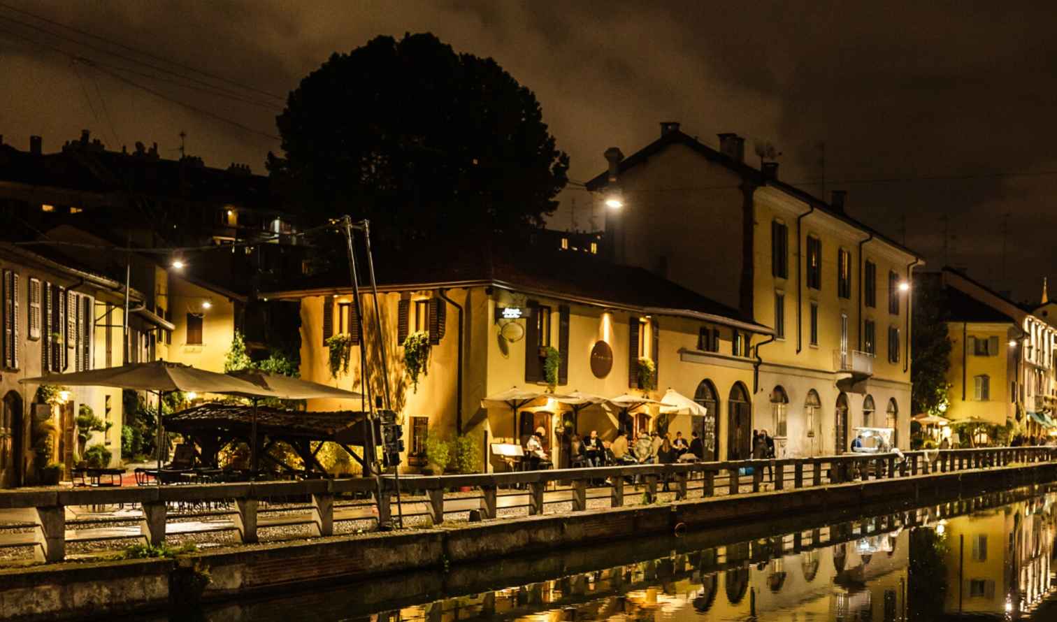Night view of Navigli canal with restaurants in Milan, Italy.