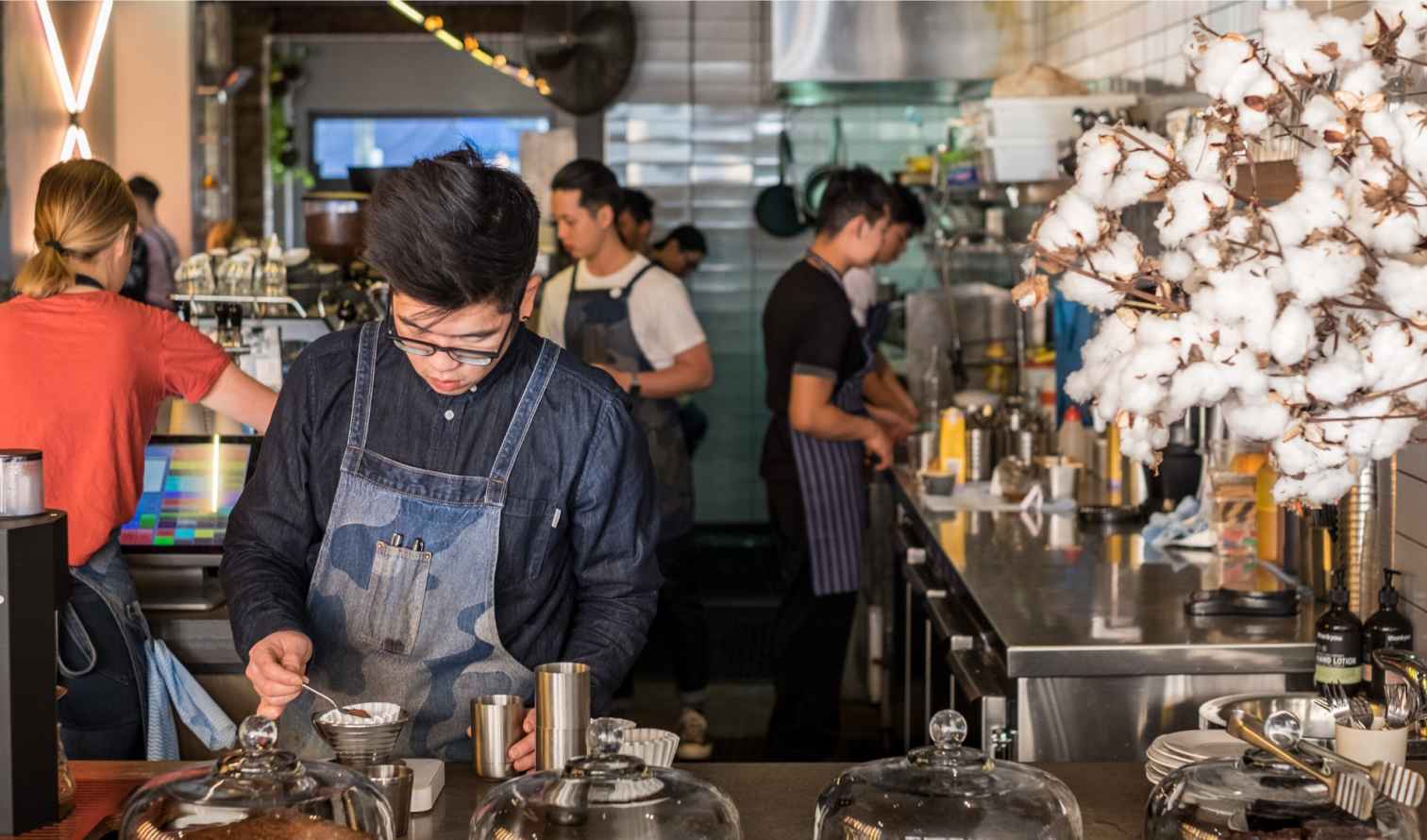 Barista focused on preparing coffee at a cafe counter in Sydney