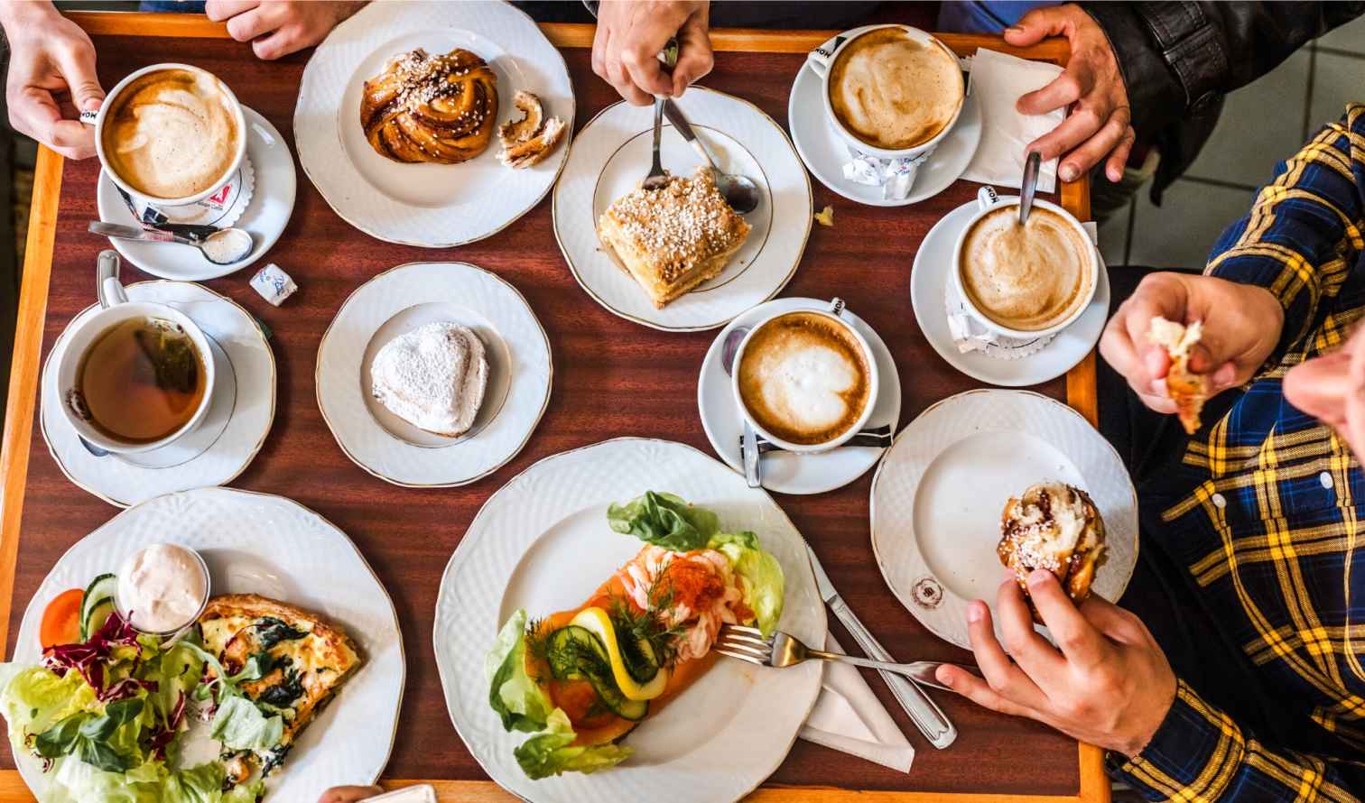 Aerial view of a table with various pastries and coffees in Stockholm