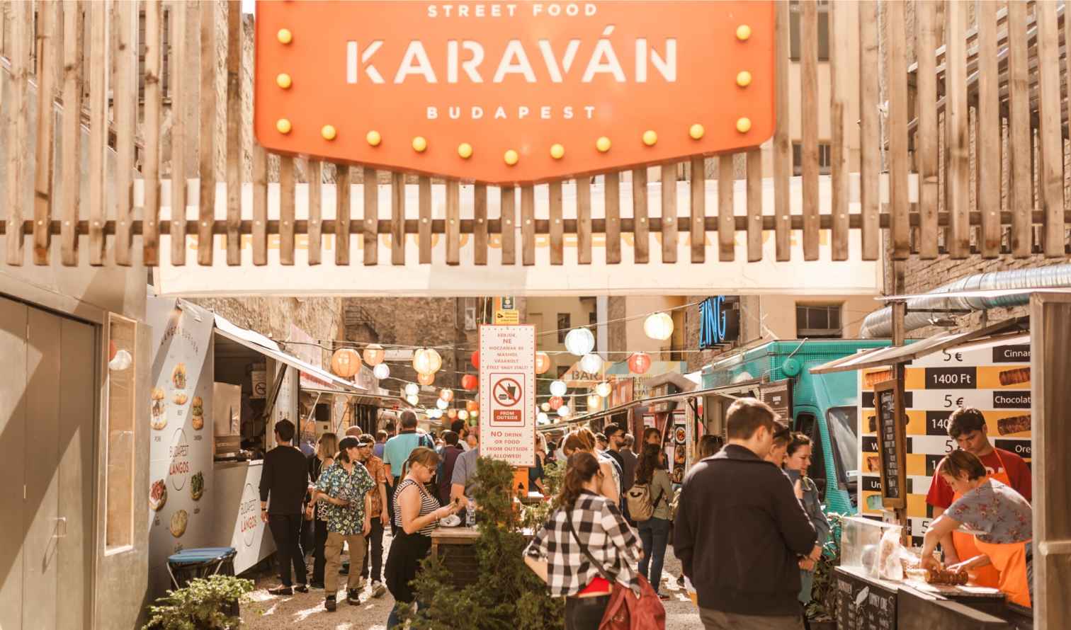 Karaván Street Food market in Budapest with food stalls and visitors.