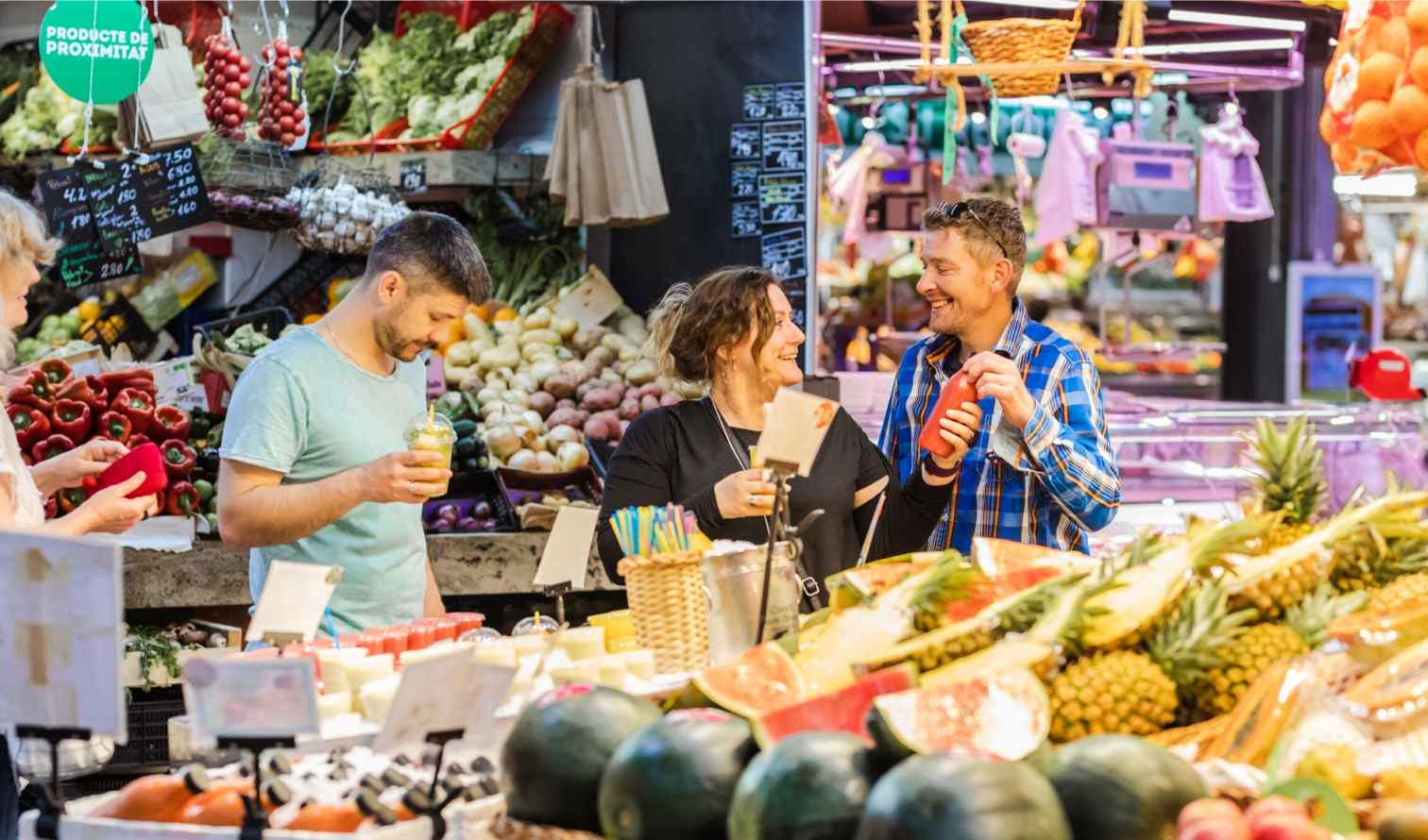 People shopping in a colorful fruit and vegetable market  in Barcelona