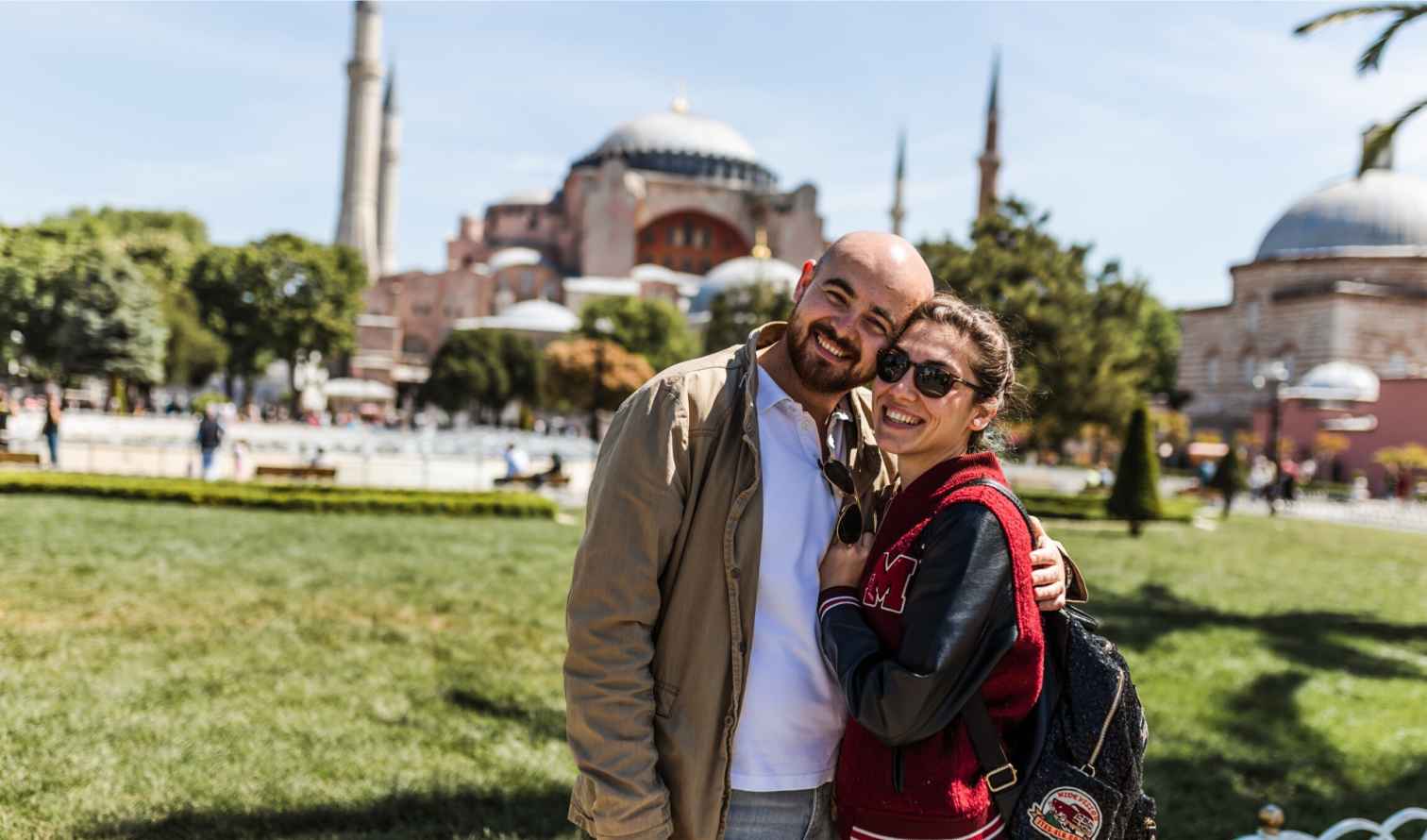 Couple posing in front of the Hagia Sophia in Istanbul.