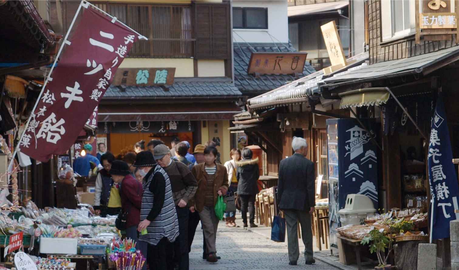 People walking along Kashiya Yokocho street in Kawagoe, Japan.