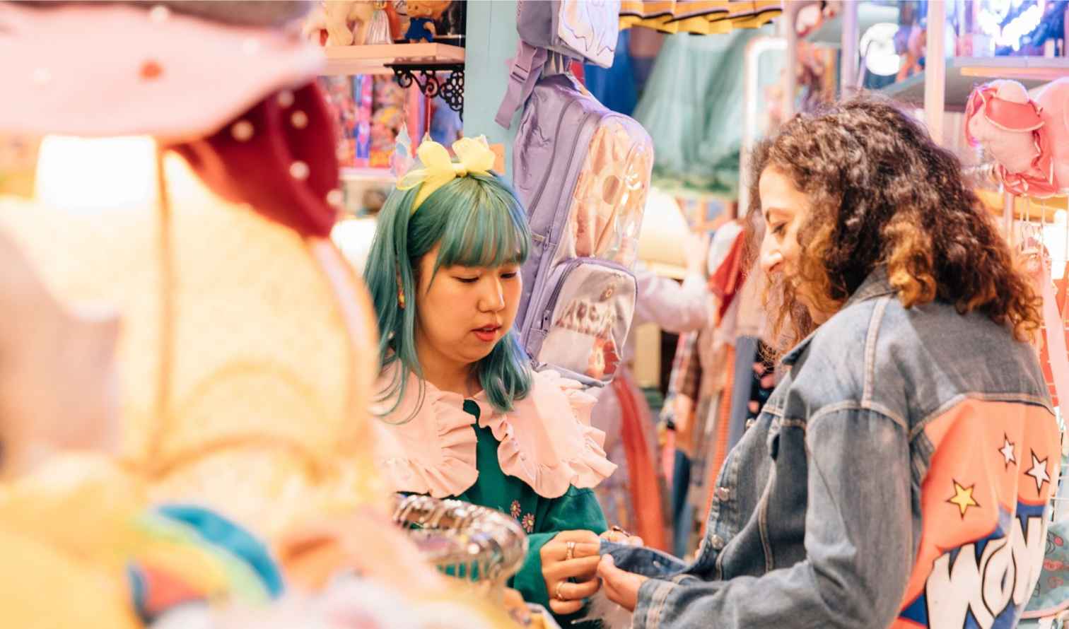 Two people shopping in a colorful Harajuku store in Tokyo.