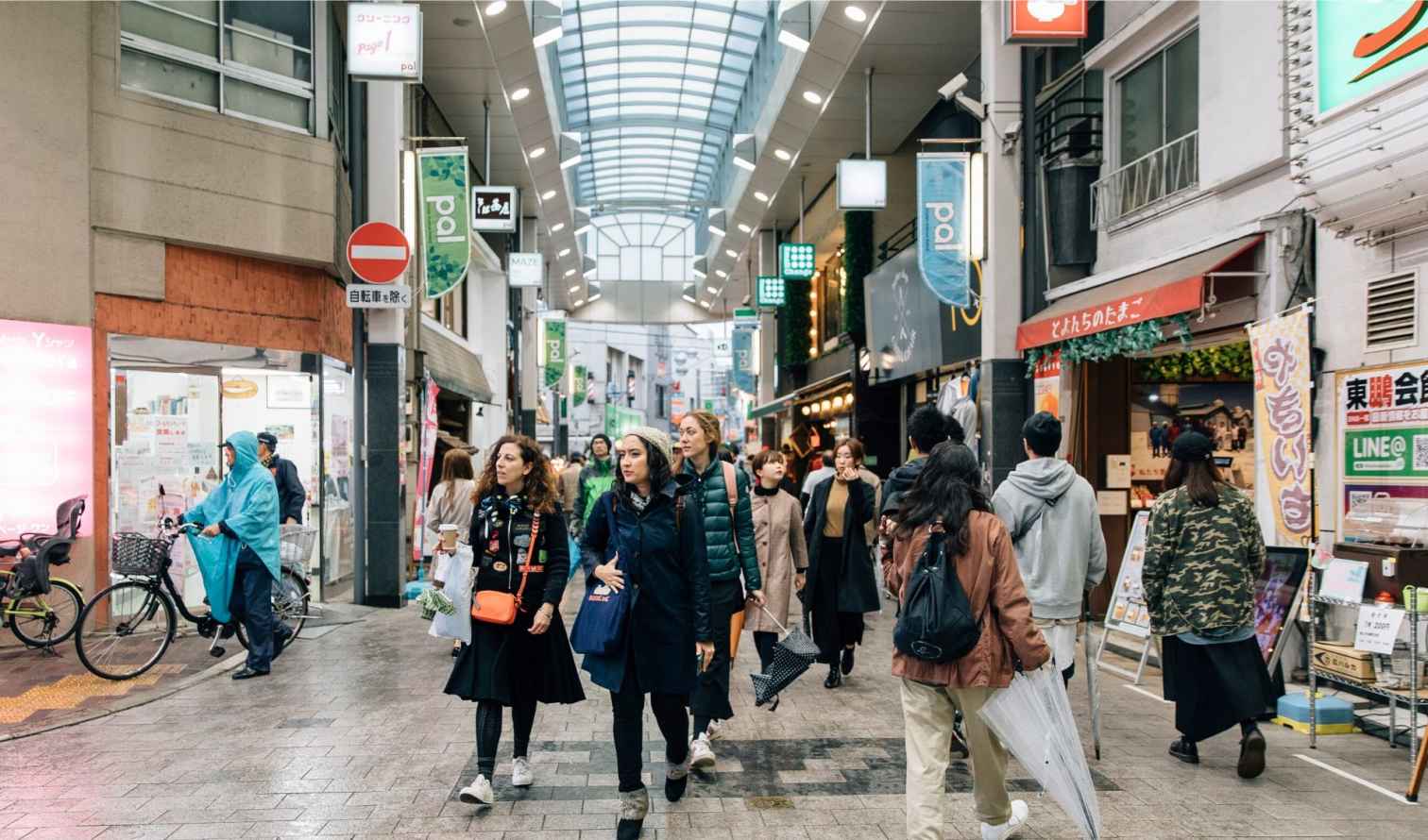 People walking in a covered shopping street in Tokyo