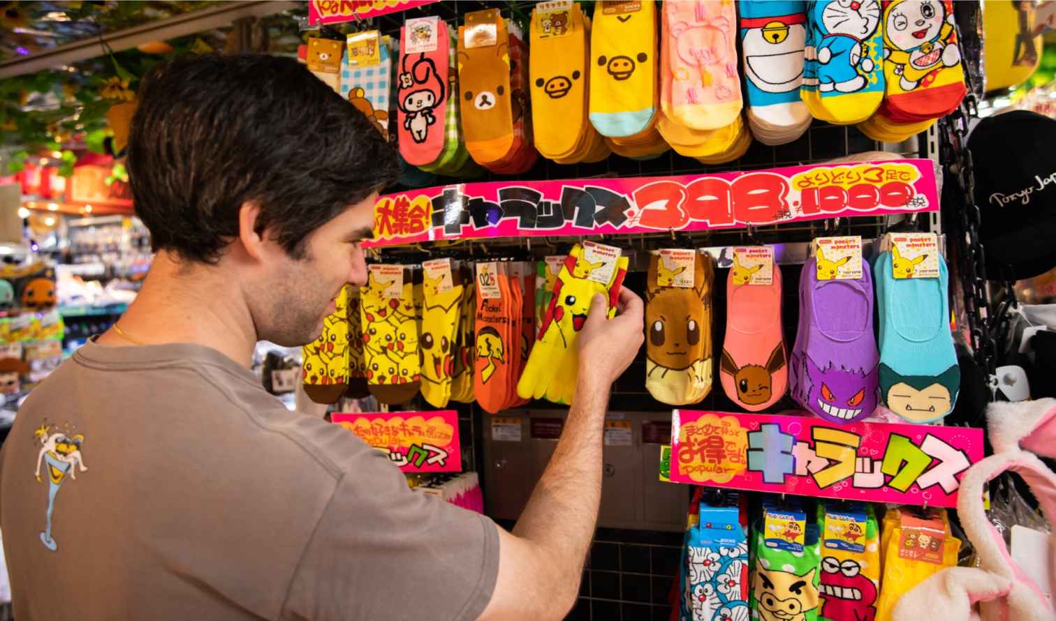 Person browsing character socks in Japanese store in Tokyo