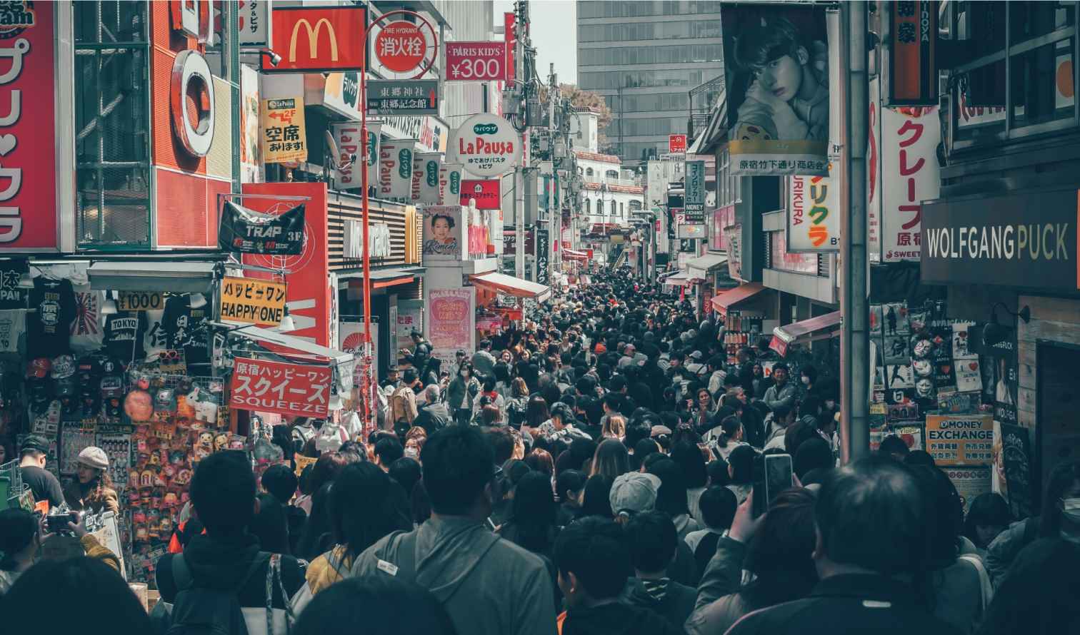 Crowded Takeshita Street in Harajuku, Tokyo, filled with people.