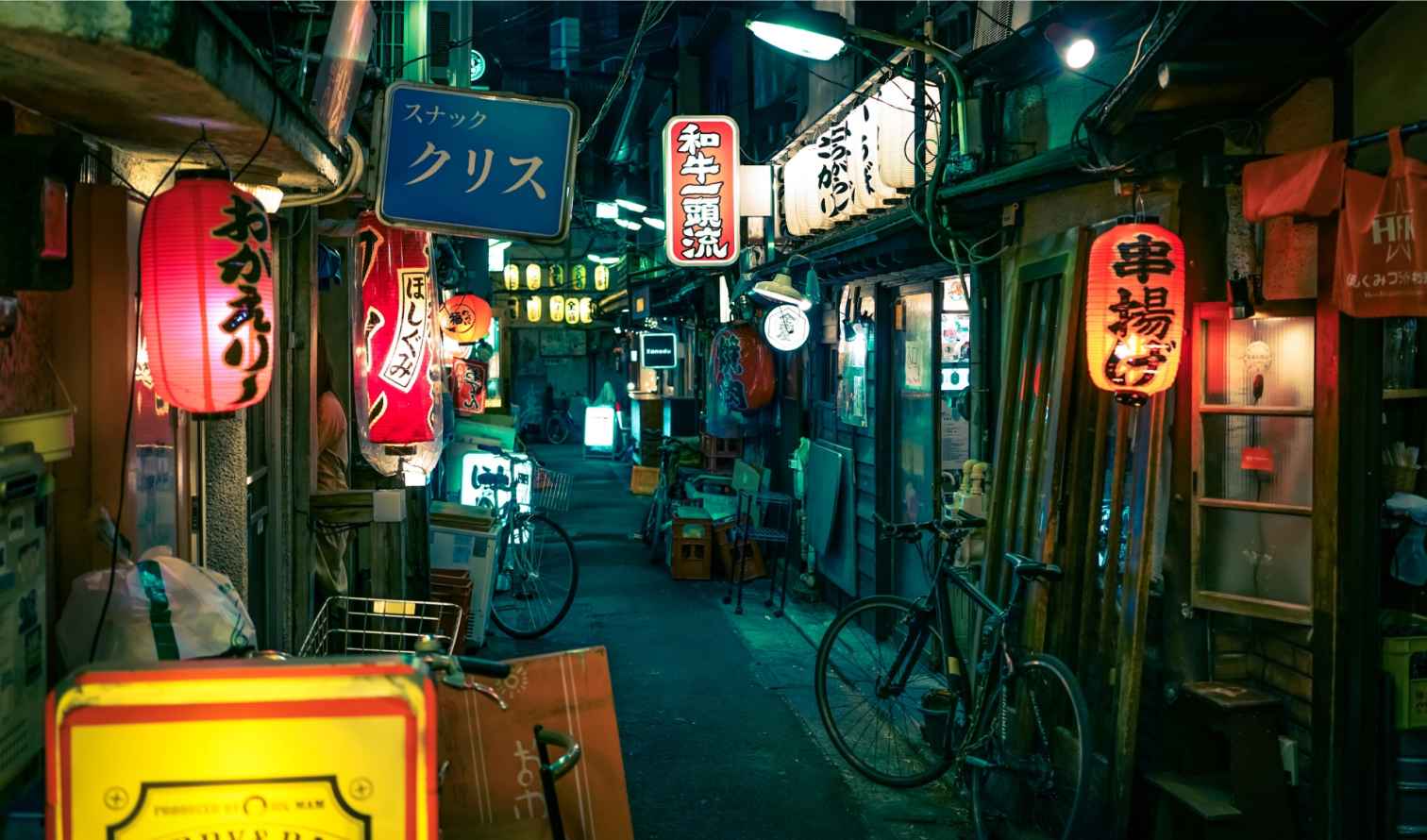 Bicycles and signs in a tight alley in Golden Gai, Tokyo, Japan.