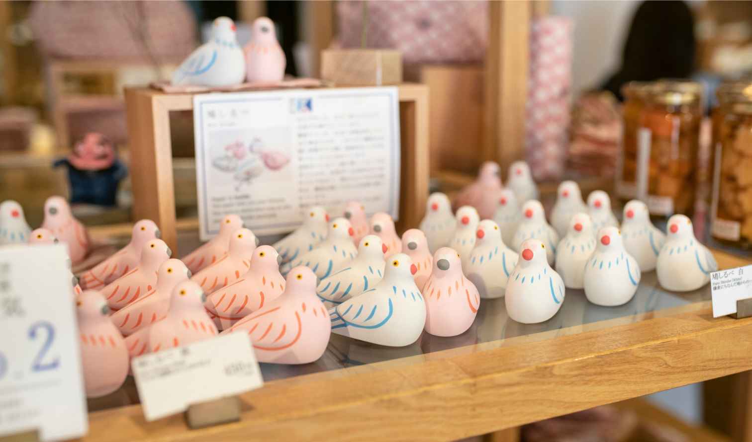 Close-up of pigeon-shaped souvenirs in Kamakura shop.