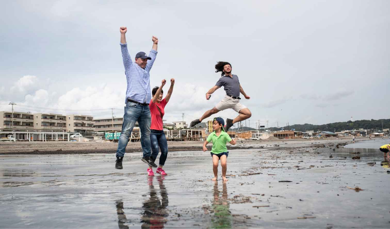Group of people enjoying a jump on the shoreline  in Tokyo