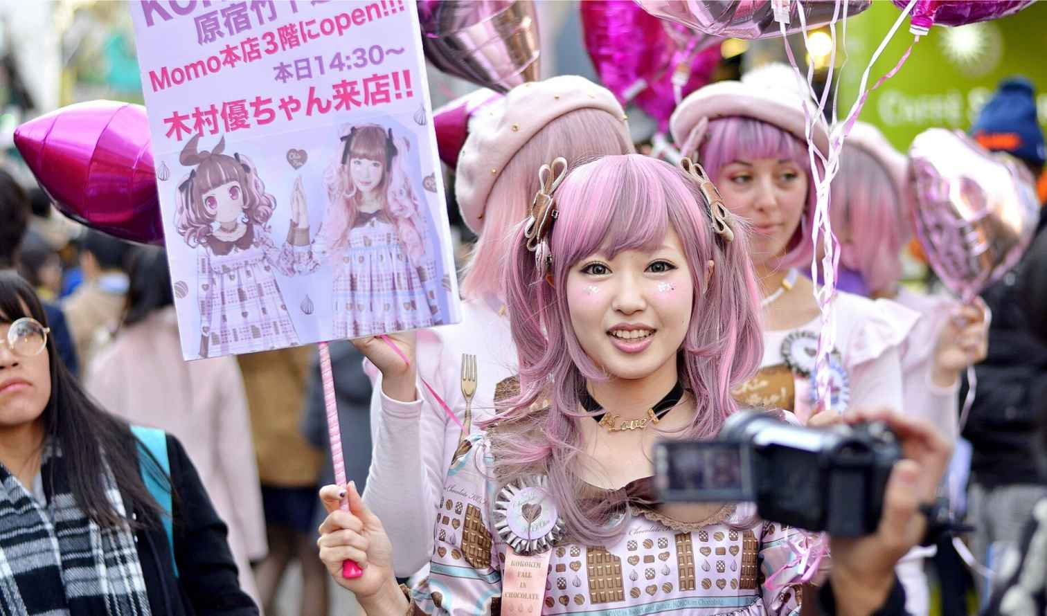 Group of people in Harajuku holding a sign with anime character in Tokyo