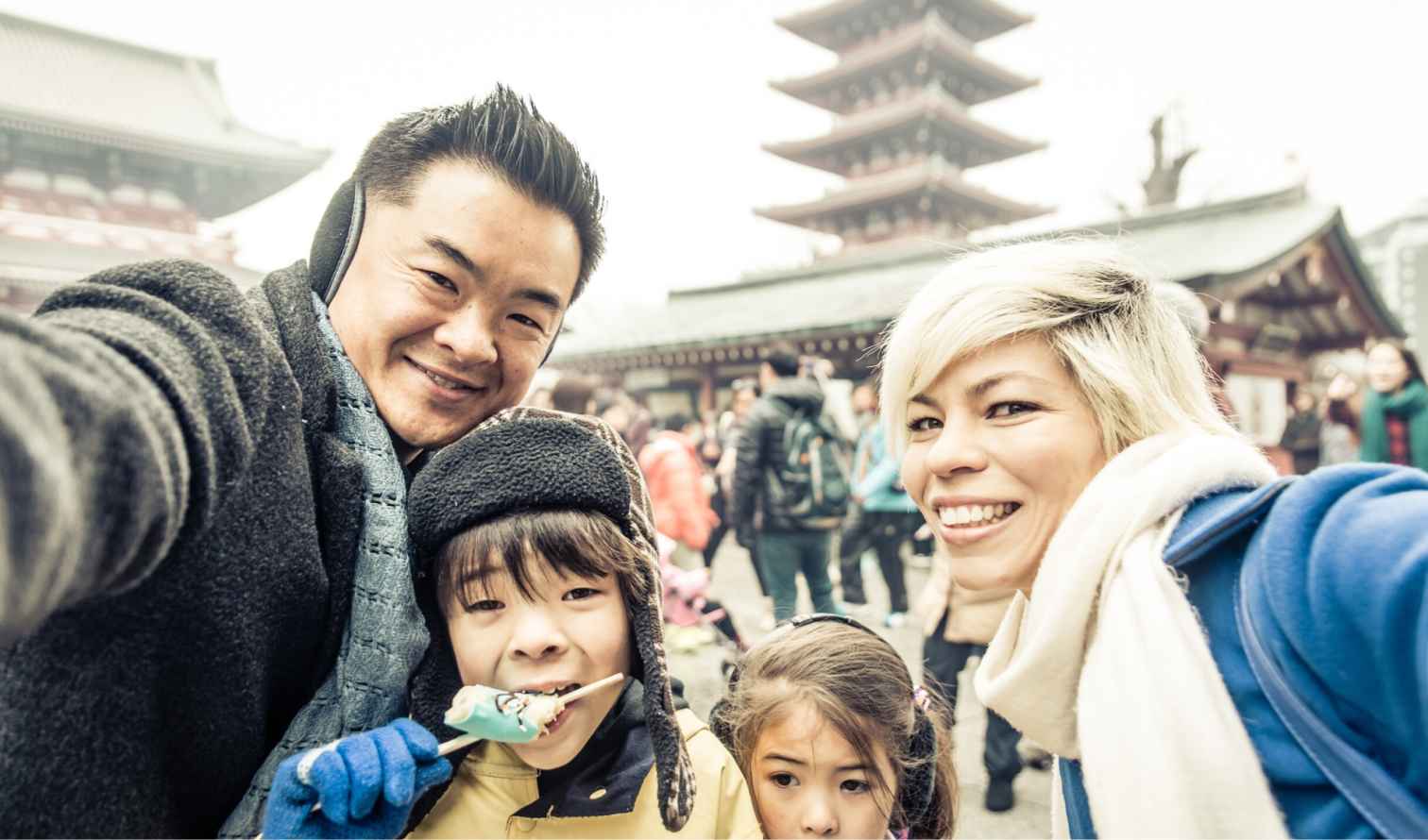 Family taking selfie at Senso-ji Temple in Tokyo, Japan.