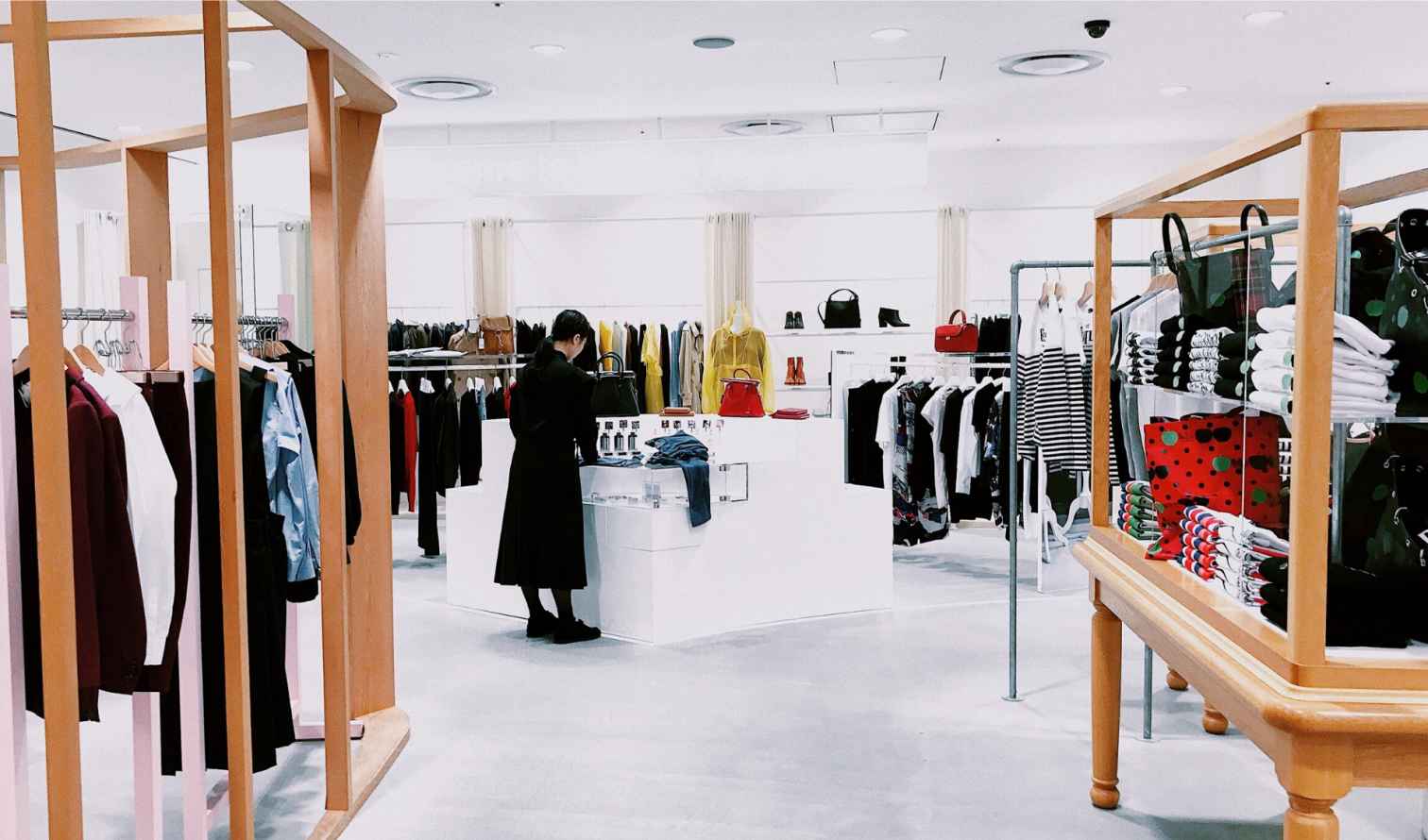 A woman shops in a brightly lit clothing store in Tokyo