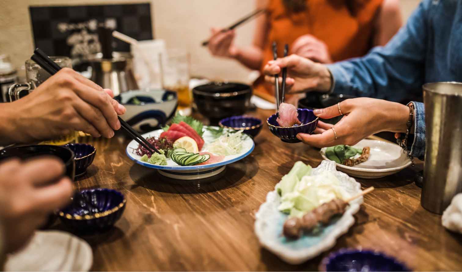 Assorted sashimi plate on a wooden table with chopsticks in Fukuoka