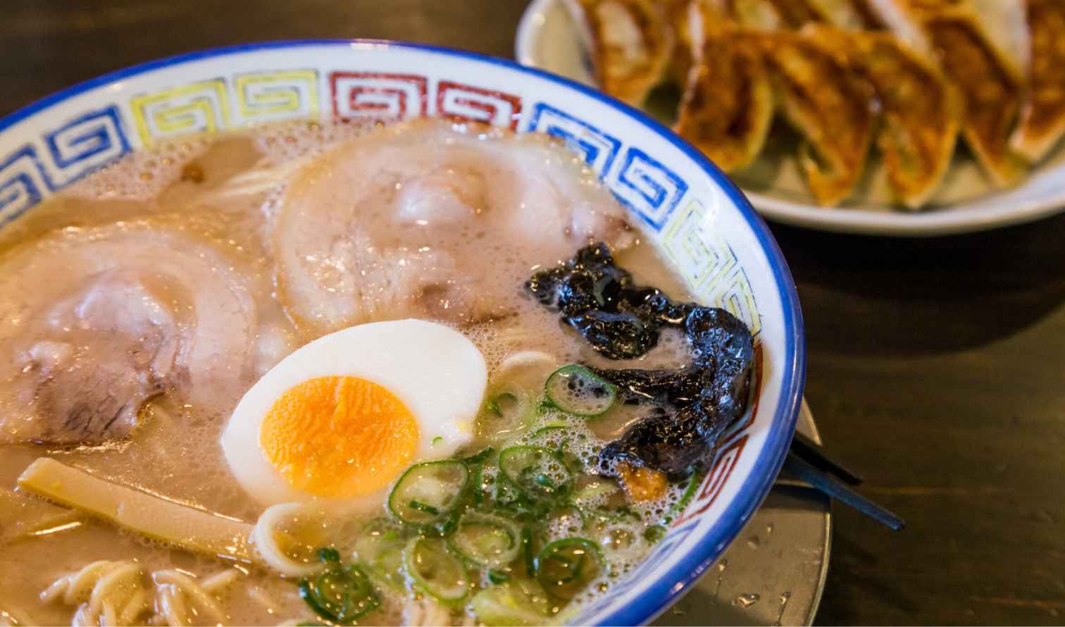 Close-up of ramen noodles topped with green onions and bamboo shoots in Fukuoka