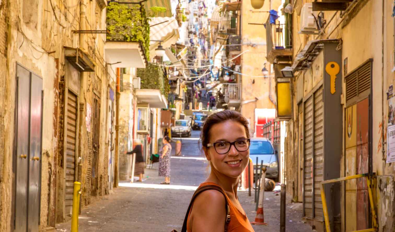 Woman standing on a narrow street in Naples, Italy.