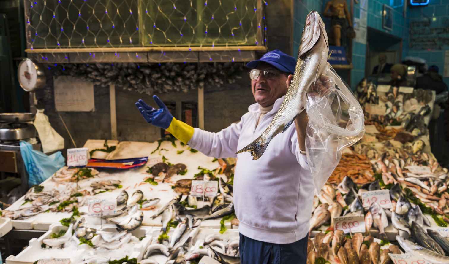 Fishmonger displaying fish at a market stall in Naples