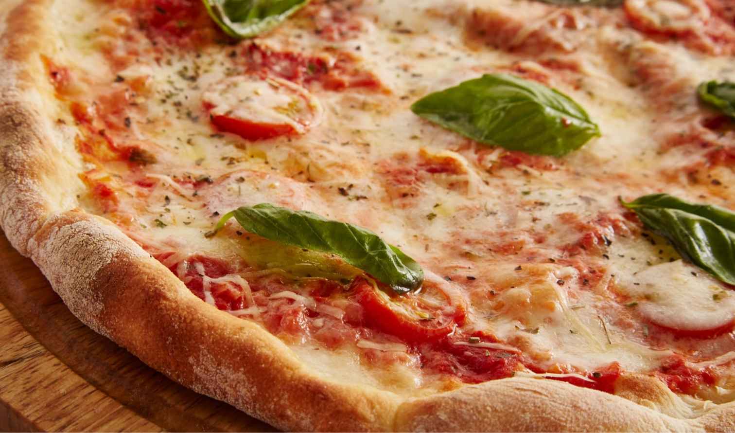 Close-up of a Margherita pizza with fresh basil leaves in Naples