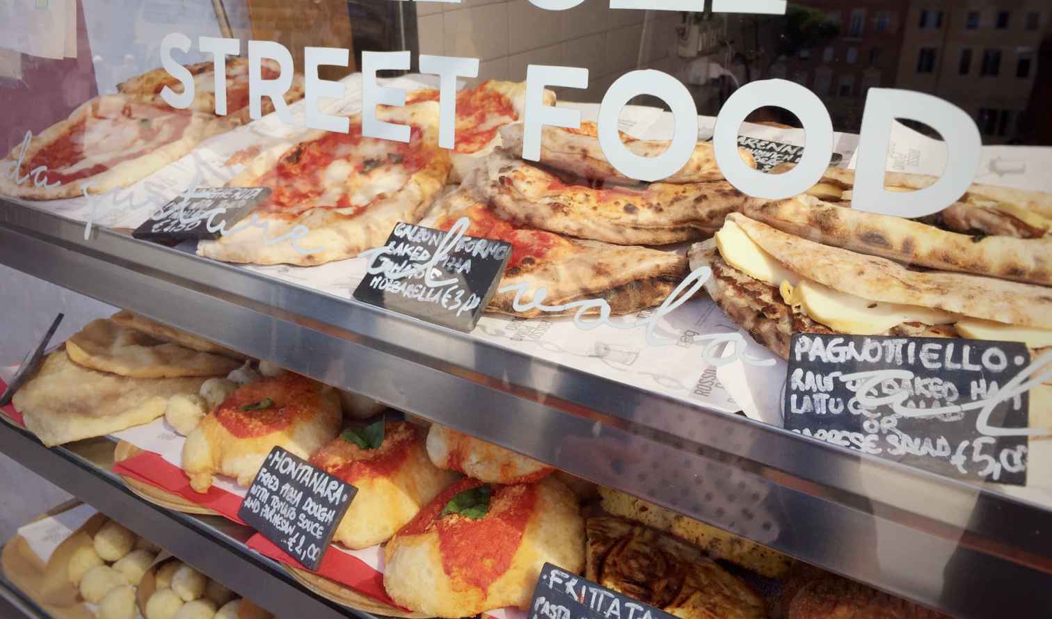 Close-up of street food items on display in Naples, Italy.