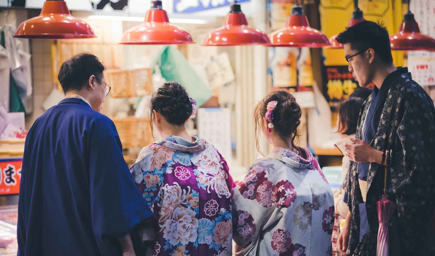 Group wearing traditional kimonos in a Japanese market in Kanazawa