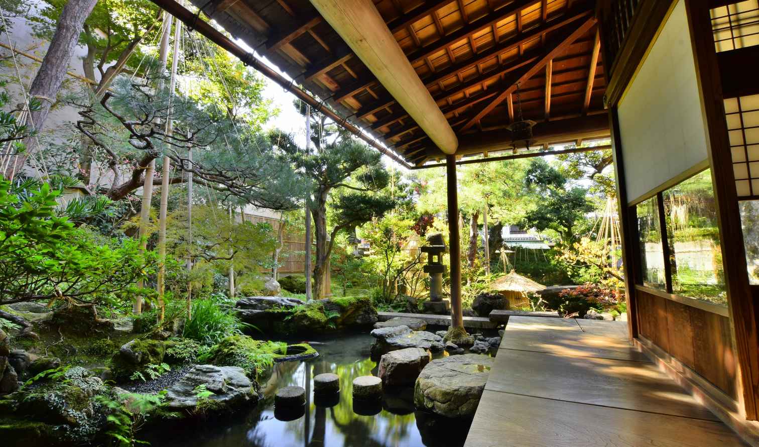 Wooden beams and sliding doors frame a garden in Japan in Kanazawa