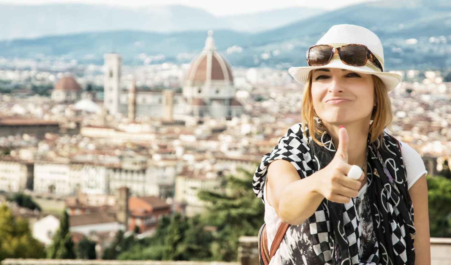 Woman giving a thumbs up in front of Florence's Cathedral Dome.