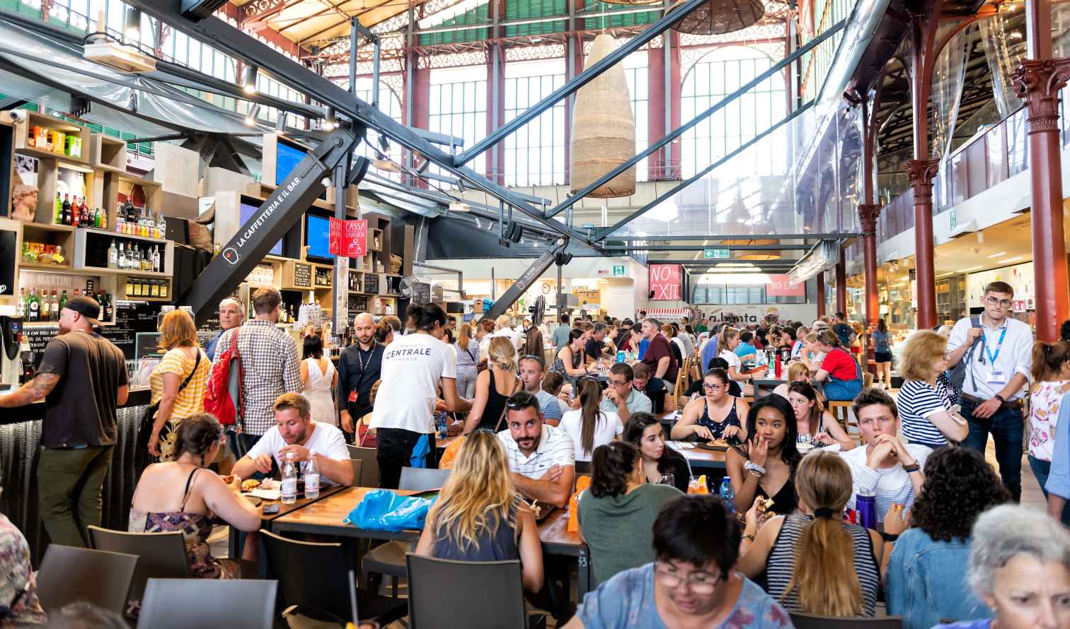 Interior of Mercato Centrale in Florence, Italy with people dining.