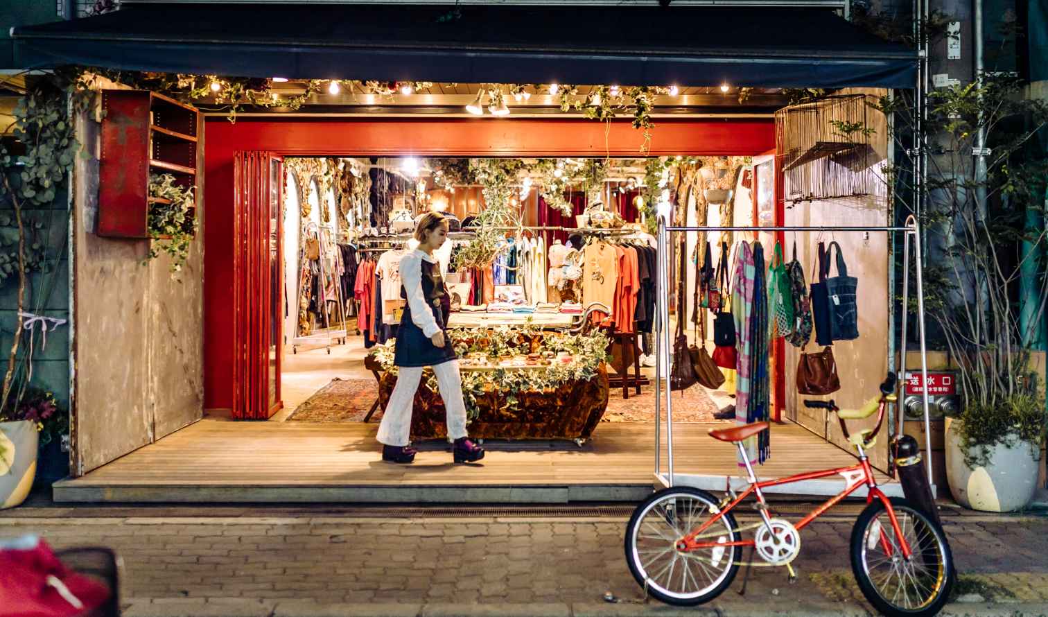 Woman walking by a vintage clothing store in Osaka