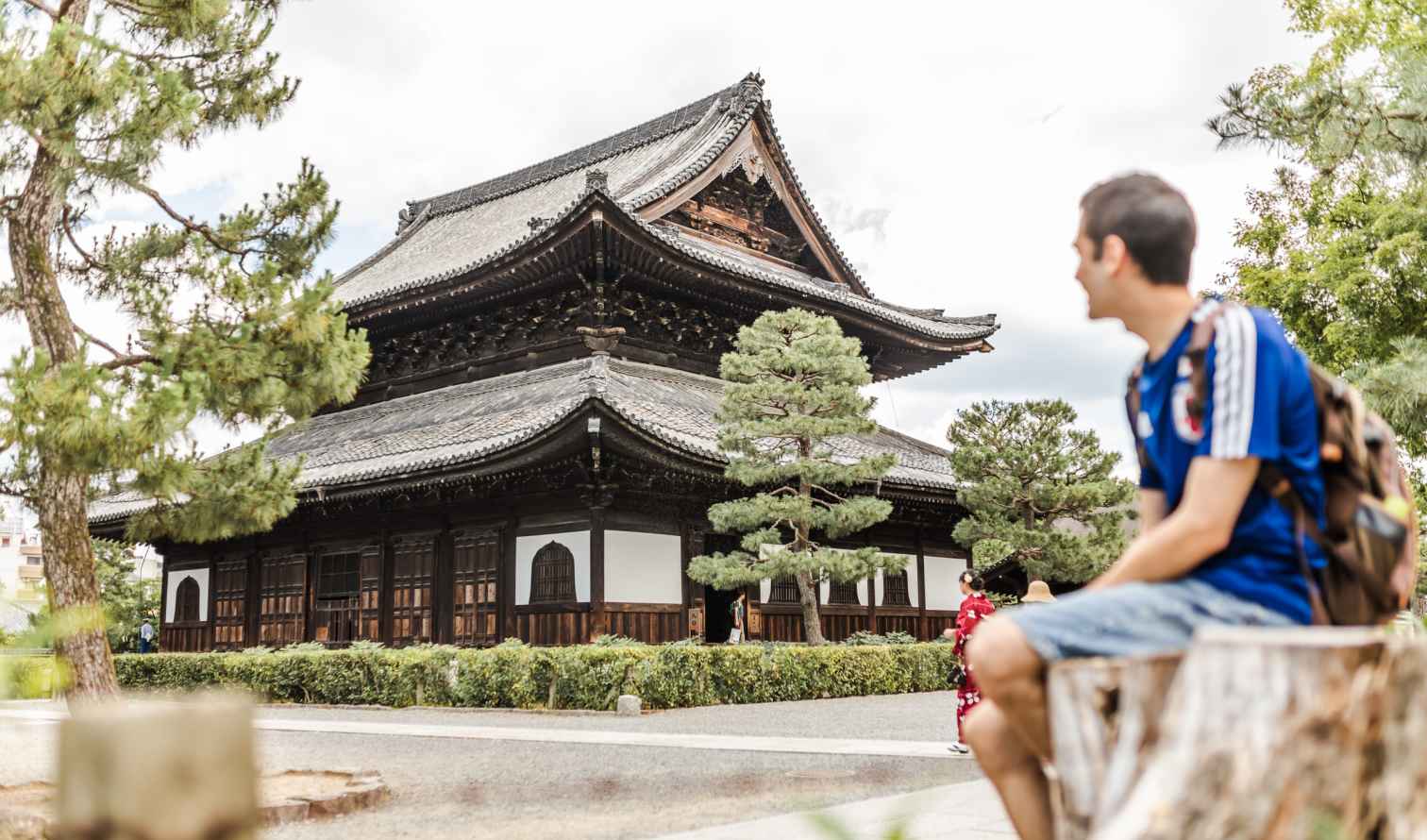 Man sitting in front of Kōfuku-ji temple in Nara, Japan.