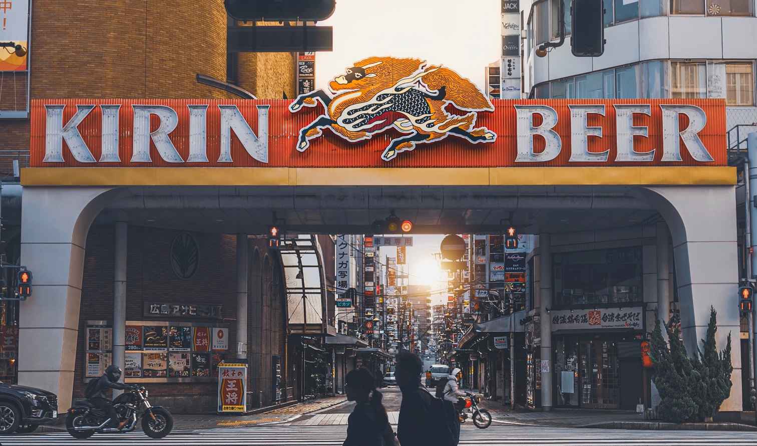 Kirin Beer sign above a crosswalk in a busy urban area in Hiroshima