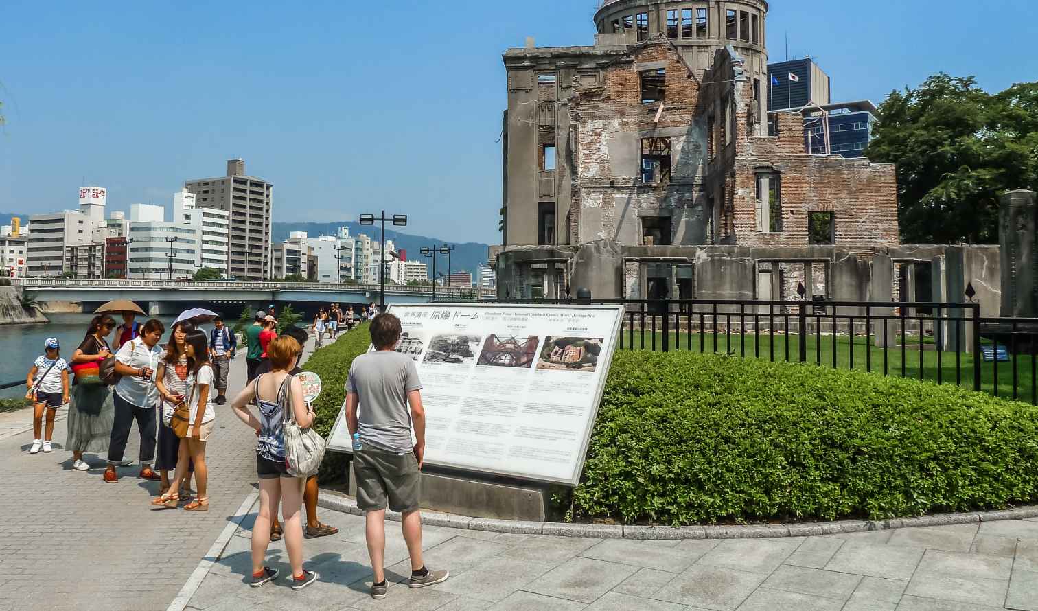 Visitors stand near the Hiroshima Peace Memorial in Japan.