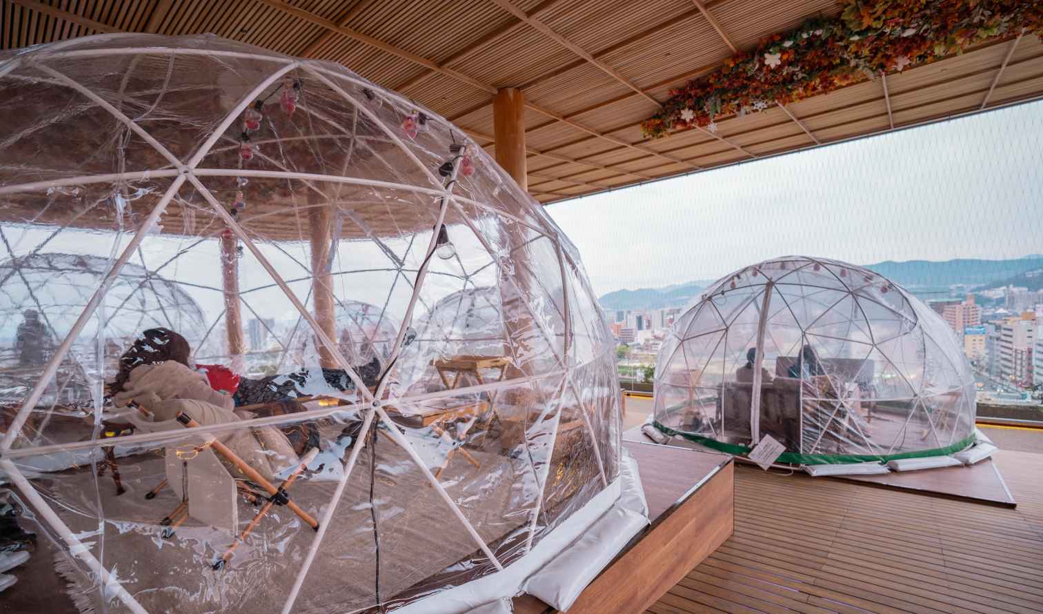 Transparent dining domes on a rooftop with city view in Hiroshima