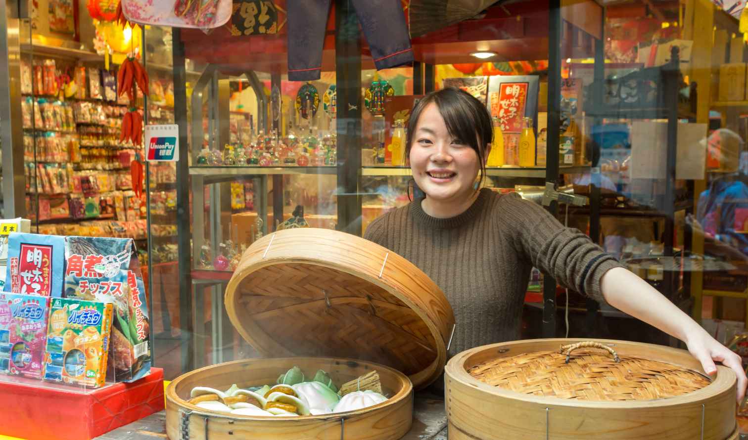 A woman selling steamed food outside a store in Nagasaki 