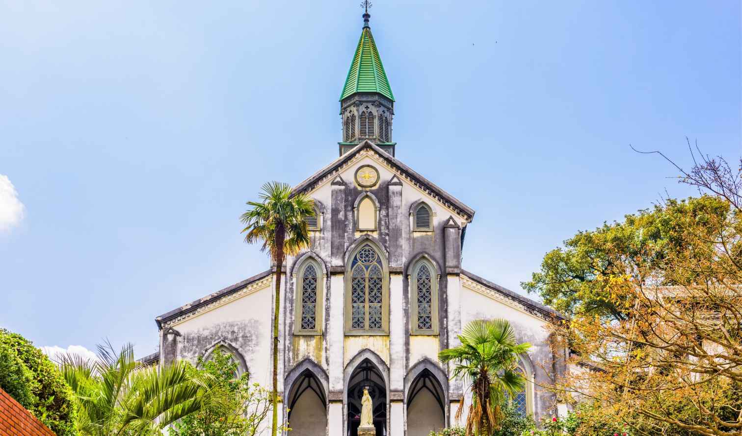 Oura Church in Nagasaki, Japan with its green spire and Gothic windows.