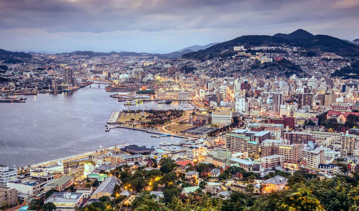 View of Nagasaki cityscape with buildings by the waterfront.