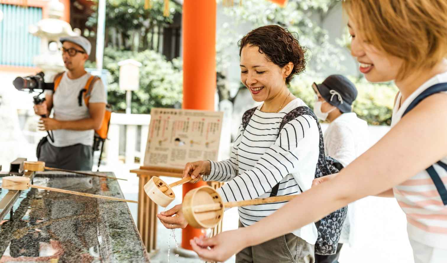 People perform purification rituals at a Japanese Shinto shrine in Nagasaki.