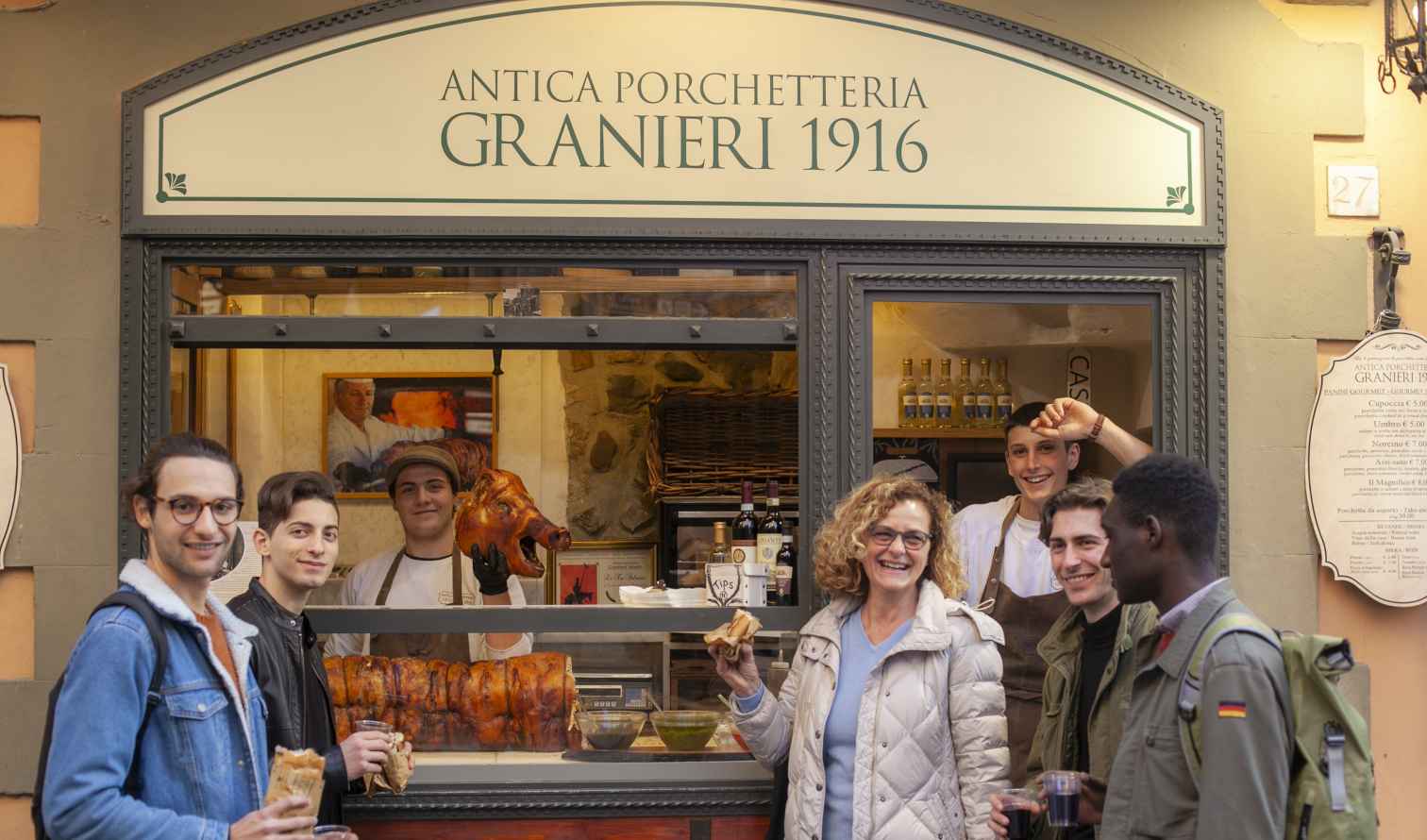 People outside Antica Porchetteria Granieri 1916 shop in Florence