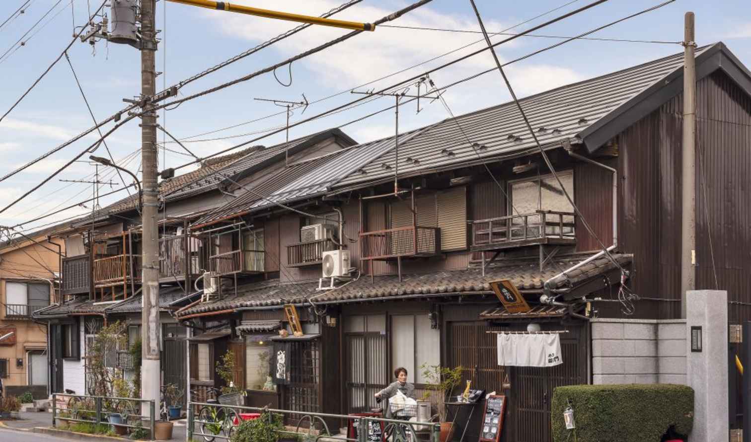 Traditional wooden buildings with signs in Tokyo