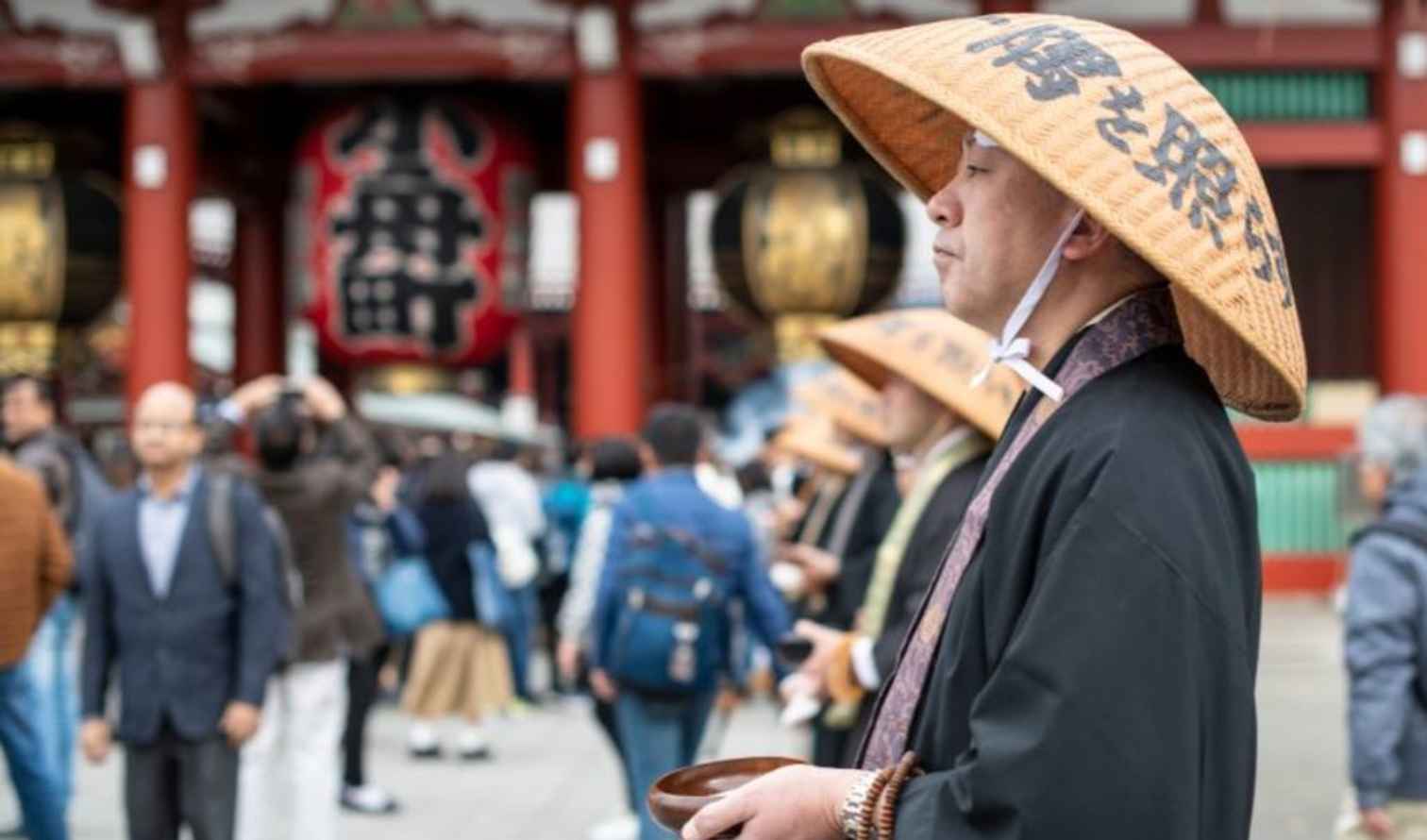 Monks in traditional attire at Senso-ji Temple in Tokyo, Japan.