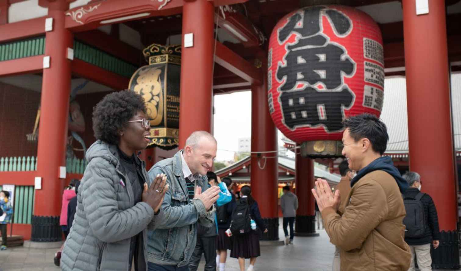 People performing a greeting at Senso-ji Temple in Asakusa, Tokyo.