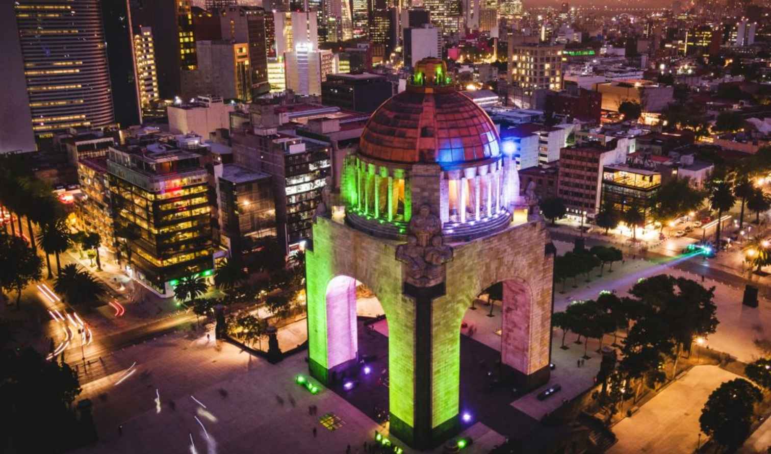 Aerial view of the illuminated Monumento a la Revolución in Mexico City.